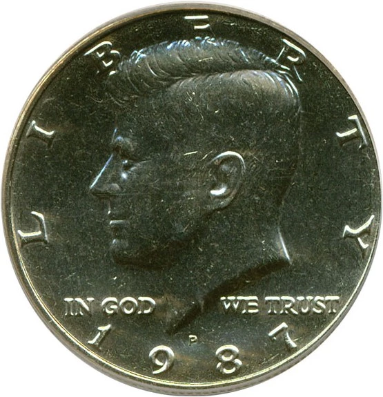 1987 Kennedy half dollar rim cud error showing raised blob at rim from broken die fragment