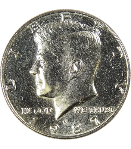 1987 Kennedy half dollar clipped planchet error showing curved section missing from coin edge